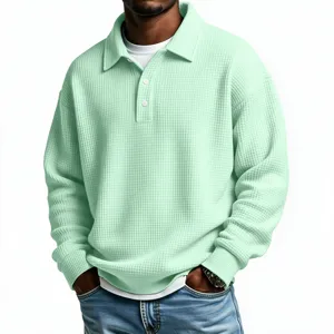 Detailed view of men's light green waffle knit long sleeve polo shirt texture and collar.