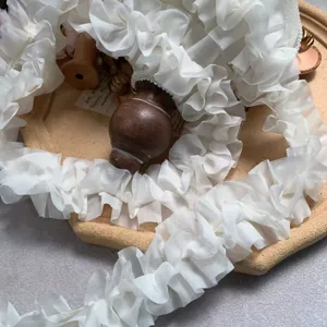 Detail shot of white chiffon lace trim, ruffled fabric ribbon for DIY sewing and crafts.