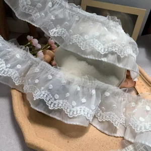 Detailed view of 8cm white double-layer mesh embroidered lace trim, delicate DIY craft fabric.