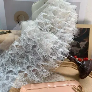 Detailed shot of white 7-layer pleated lace trim, 18cm wide ribbon for DIY decor and sewing.