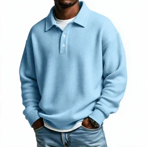 Detail of men's light blue waffle-knit long sleeve polo shirt, casual textured top.