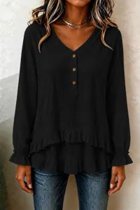Detailed shot of the black long sleeve blouse showing the V-neck and ruffled layered hem.