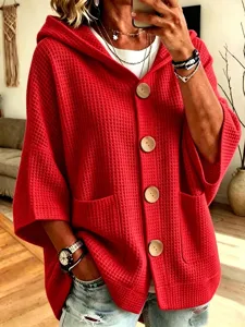 Waffle knit hooded cardigan featuring large buttons, front pockets, and relaxed casual style.