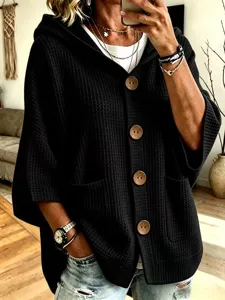 Stylish black waffle knit hooded cardigan featuring large wooden buttons and cozy pockets.
