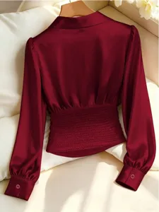 Wine red satin blouse back view, cinched waist with pleats and long sleeves detail.