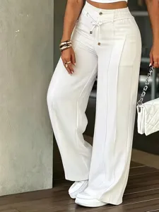 White wide-leg trousers detail featuring front center creases, drawstring waist, and elegant drape.
