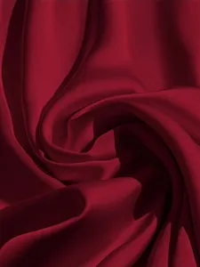 Burgundy satin fabric detail shot, smooth texture and elegant soft folds close-up design.