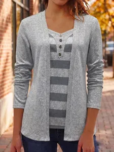 Detailed view of the women's striped fake two-piece long sleeve top with button accents.