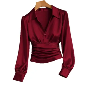 Elegant burgundy satin lapel long sleeve blouse with ruched waist and V-neck design.