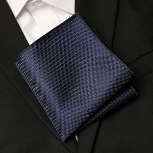 Dark blue woven pocket square detail, classic suit accessory fabric texture close-up.