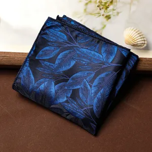 Vista dettagliata della pochette elegante da uomo con motivo a foglie blu per abiti formali.