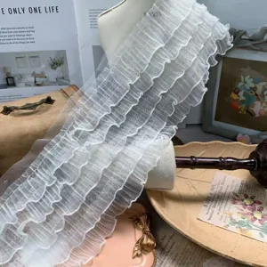Detail shot of 15cm wide 5-layer white ruffled mesh lace trim for crafts and doll clothes.