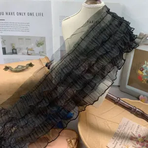 Detailed view of 15cm black 5-layer ruffled lace tulle trim for doll dress and curtain decor.