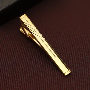 Gold metal tie clip for men, elegant business suit accessory with geometric engraved pattern.