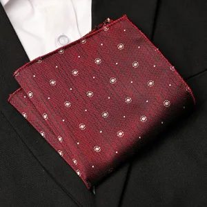 Detail view of a burgundy men's pocket square with micro dot pattern for formal suit wear.