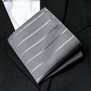 Men grey striped pocket square for suit, elegant business handkerchief fashion accessory detail.