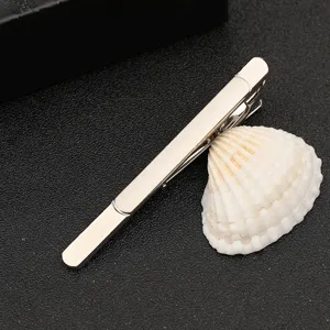 Silver metal tie clip detail view, minimalist design for business men formal wear and suits.