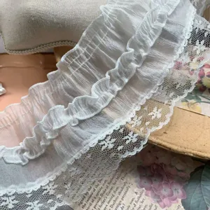 Detail view of 9cm white chiffon pleated lace trim, delicate sheer fabric for DIY crafts.