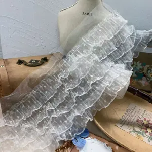 Detail view of 5-layer white polka dot mesh lace ruffle trim, perfect for DIY and doll clothes.