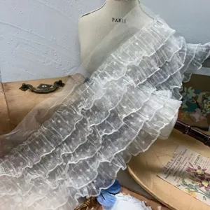 Detail view of 15cm white 5-layer polka dot mesh ruffled lace trim for DIY doll clothes.