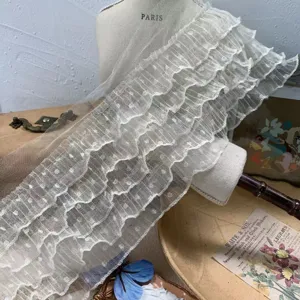 Detailed close-up view of white five-layer dotted mesh lace ruffle trim for DIY crafts.