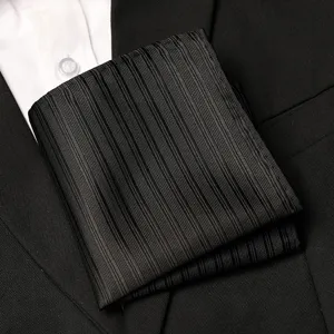 Detailed view of a black pleated men's suit pocket square, elegant formal polyester fabric.