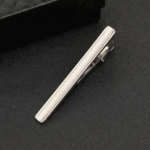 Close-up detail of a sleek silver metal tie clip for men, elegant business accessory.