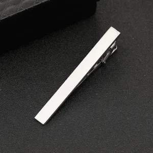 Silver tie clip detail shot featuring brushed metal finish and sleek minimalist bar design.