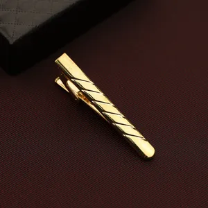 Gold tie clip for men, stylish metal tie bar with diagonal stripes for business formal wear.