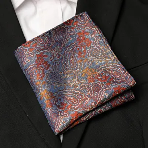 Close up of blue and orange paisley pocket square detail, elegant suit accessory.