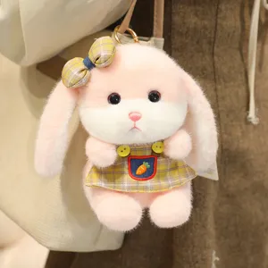 Plush rabbit pendant detail showing soft pink fur, yellow plaid dress, and cute bow decoration.