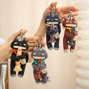 Handmade fabric cat keychains, cute plush animal charms holding plaid fish for bags and keys.