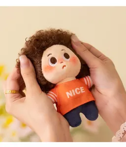 Plush doll pendant detail view, showcasing fluffy curly hair texture and cute mini outfit clearly.