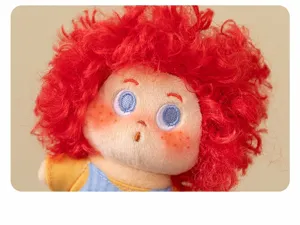 Detail of cute fluffy cotton doll pendant with red curly hair and lovely freckles face.