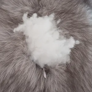 Close-up of fluffy toy stuffing with soft grey faux fur and white plush filling material.