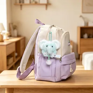 Cute aesthetic dual-color school backpack with adorable plush elephant keychain pendant.