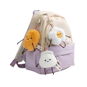 Cute mini backpack with plush keychains, adorable fried egg and bun stuffed doll charms.