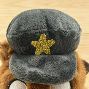 Cute plush toy detail shot showing a soft stuffed animal wearing a grey cap with gold star.