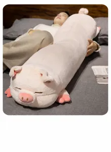 Pink plush pig long body pillow detail shot showing comfortable sleep support on cozy bed setup.