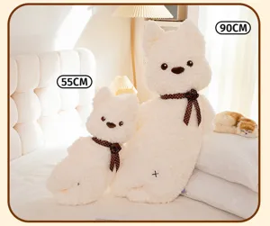 Cute white dog plush long pillow with brown polka dot bow, soft stuffed animal toy for bed.