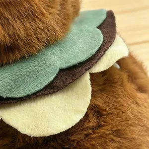 Close-up detail of cute plush toy with layered felt burger design and soft brown fur texture.