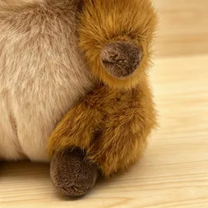 Plush toy detail closeup showing soft brown fur and paw texture for cute animal doll.