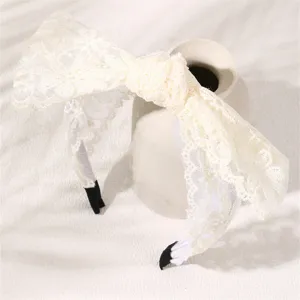 White lace bow headband detail view, exquisite fabric texture and neat stitching finish.