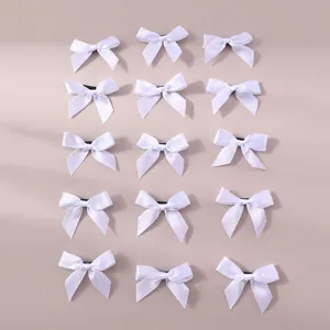 Detail shot of white ribbon hair bows, neat grid arrangement, sweet daily hair accessories.