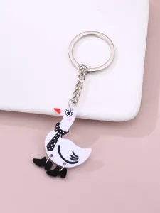 Porte-clés canard mignon avec écharpe à pois et bottes, charmant accessorio de sac pour tous.