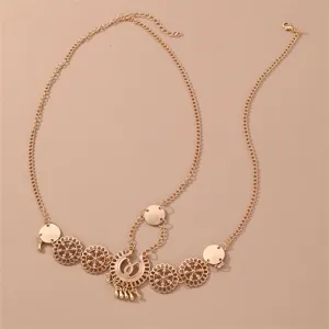 Detailed view of the vintage gold forehead chain, featuring delicate hollow-out floral metal charms.