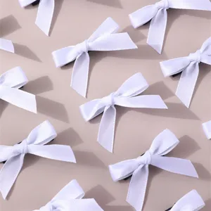 Detail view of minimalist white ribbon bow hair clips set, featuring elegant sweet design.