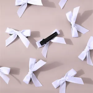 Detailed view of white ribbon hair bow clips, minimalist sweet style sweet hair accessories set.