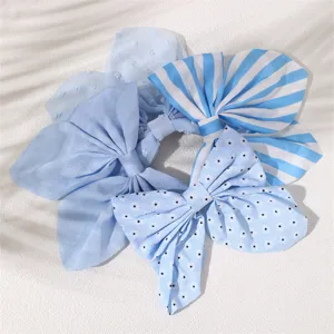 Λεπτομέρεια μπλε σετ scrunchie με φιόγκο μαλλιών, κομψά υφασμάτινα αξεσουάρ.