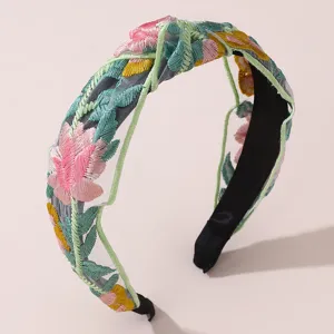 Floral embroidered wide headband with sheer mesh overlay and black base for women's fashion.